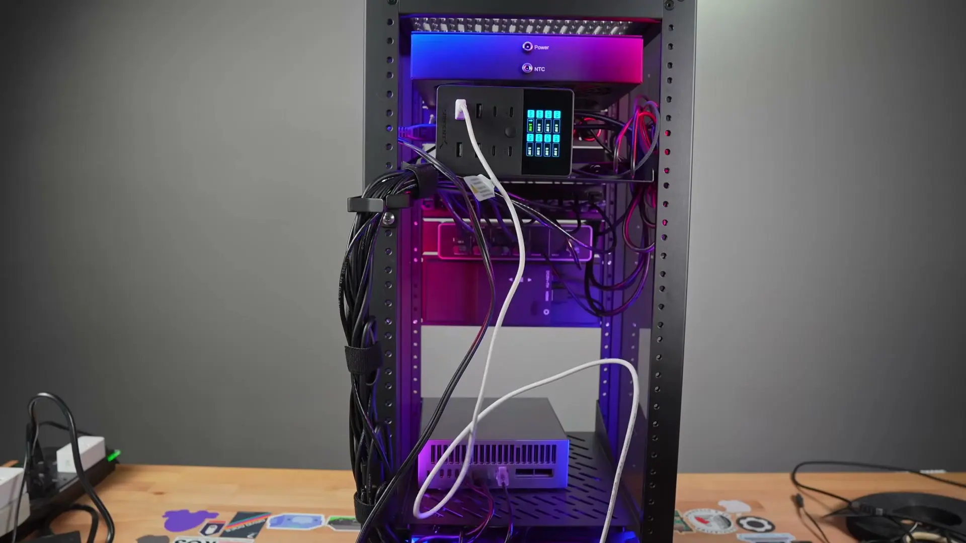 Rear view of the mini rack with PDU, power adapters, D-rings, Velcro, and bundled cables